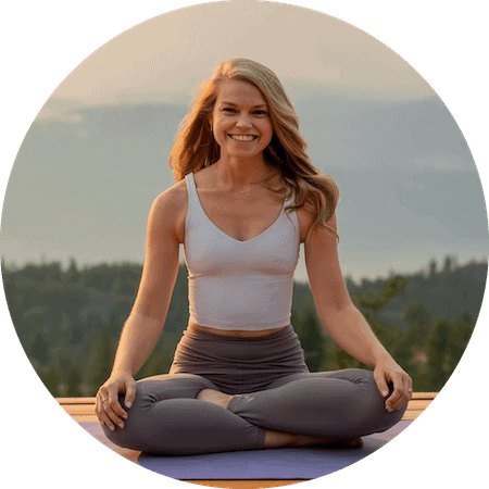 Peaceful young woman practicing yoga outdoors for mindfulness and stress relief.